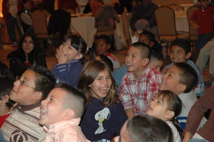 Children of renaissance hotel laugh so hard while watching magician Paul
